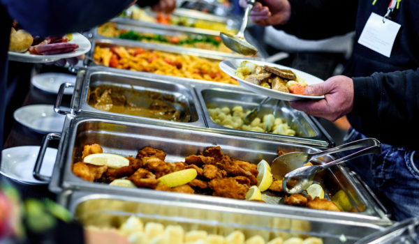 Cuisine Culinary Buffet Dinner Catering Dining Food Celebration Party Concept. Group of people in all you can eat catering buffet food indoor in luxury restaurant with meat and vegetables.